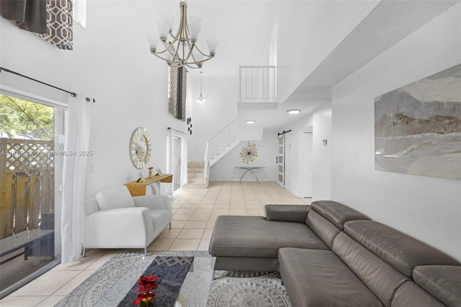 8500 Southwest 109th Avenue, Unit 6112 Miami, FL 33173 - Photo 6 of 52 a living room with furniture and a flat screen tv