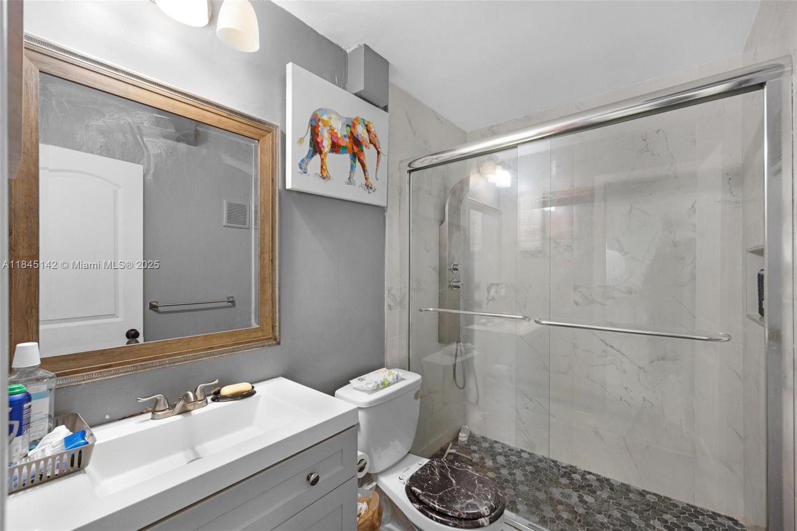 8500 Southwest 109th Avenue, Unit 6112 Miami, FL 33173 - Photo 9 of 52 a bathroom with a sink and a mirror