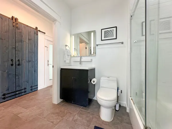 a bathroom with a toilet a sink and shower