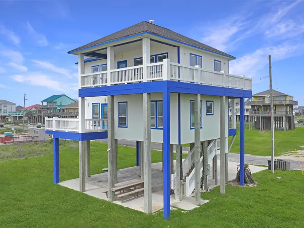 a front view of a house with a yard table and chairs