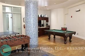 1830 Radius Drive, Unit 1417 Hollywood, FL 33020 - Photo 3 of 6 a living room with furniture and a table