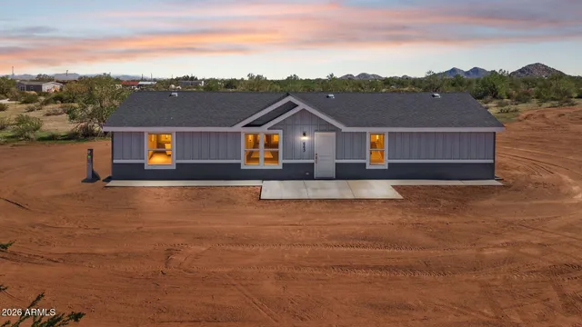 an aerial view of residential houses with outdoor space and ocean view