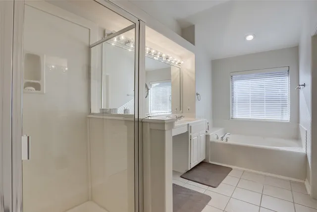 a bathroom with a bathtub and a shower