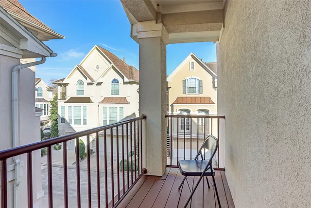 a view of a brick house with large windows