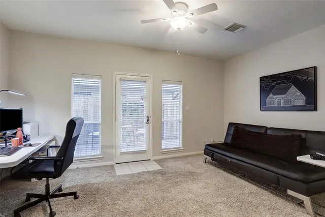a livingroom with workspace and a window