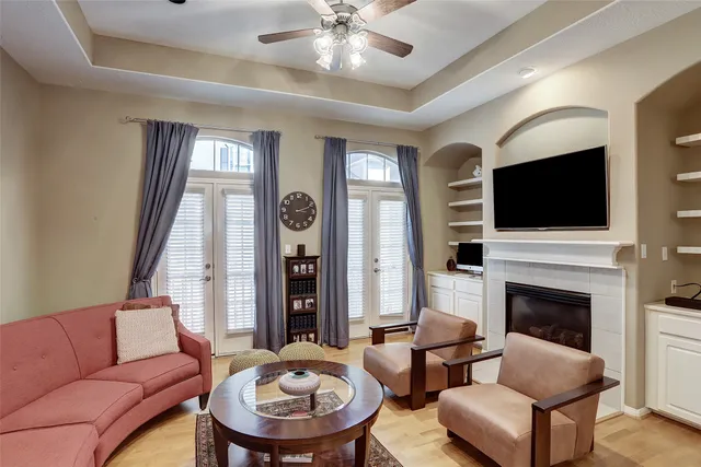 a living room with furniture a fireplace and a flat screen tv