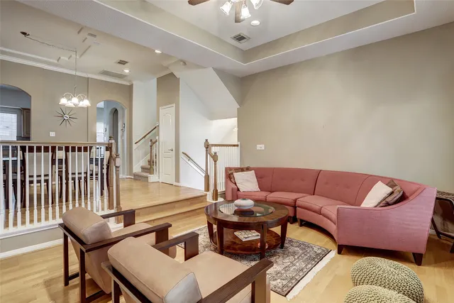 a living room with furniture and a chandelier