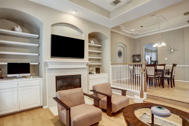a living room with furniture a flat screen tv and a fireplace