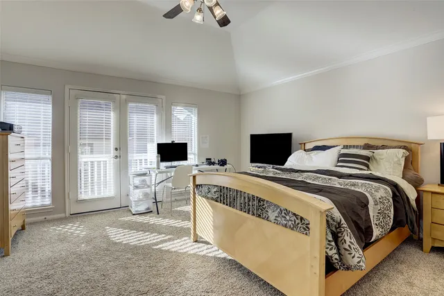 a bed room with a bed and a television