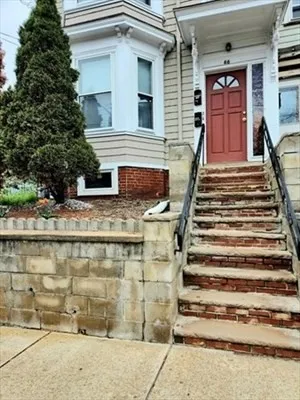 a front view of a house with stairs