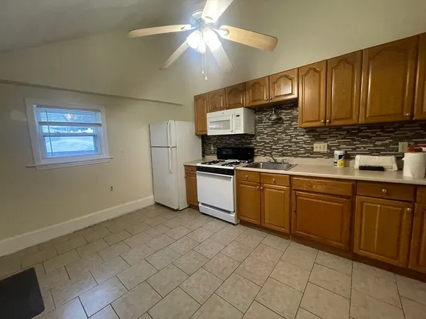 a kitchen with cabinets a sink and appliances