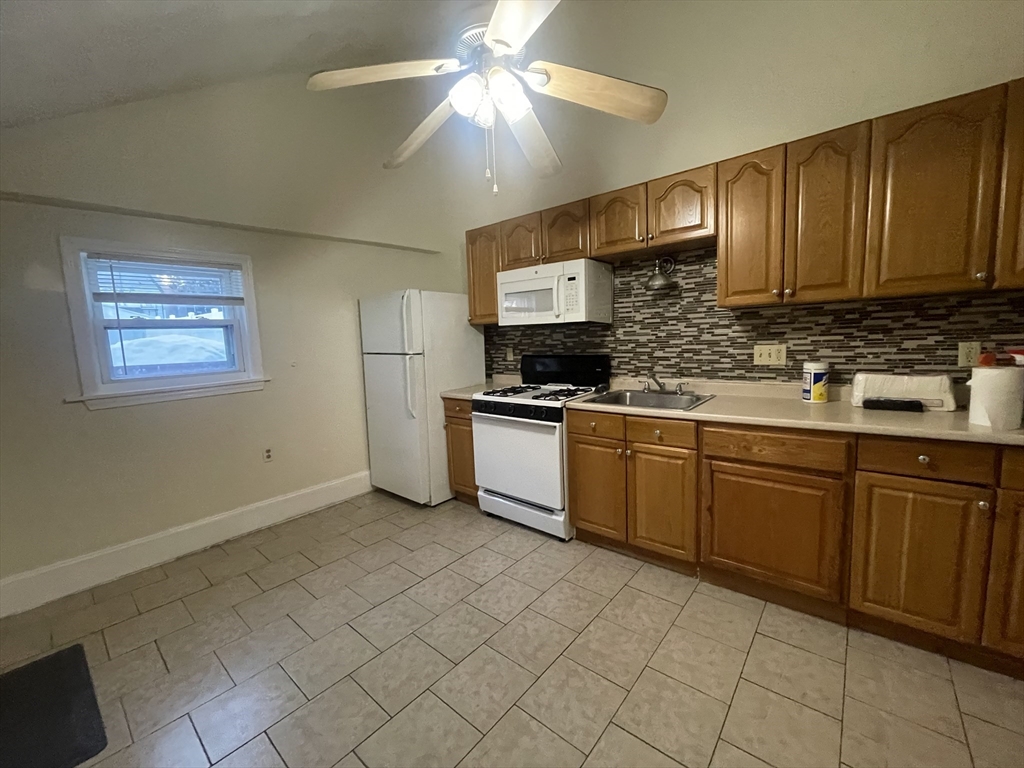 66 Pearl Street, Unit 1 Chelsea, MA 02150 - Photo 8 of 10 a kitchen with cabinets a sink and appliances