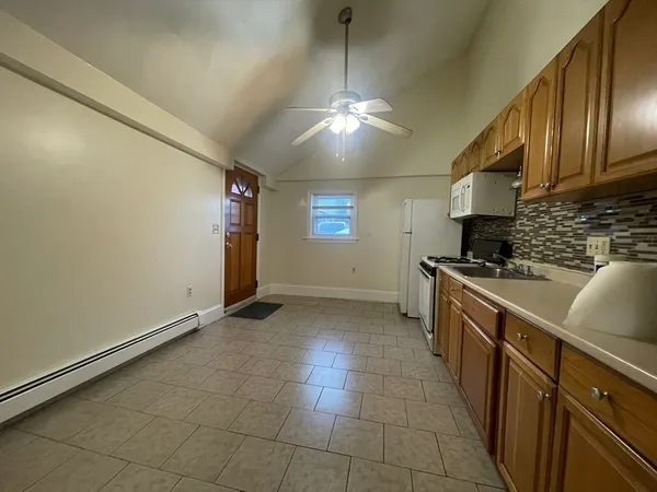 a kitchen with stainless steel appliances granite countertop a sink a stove top oven a counter space and cabinets