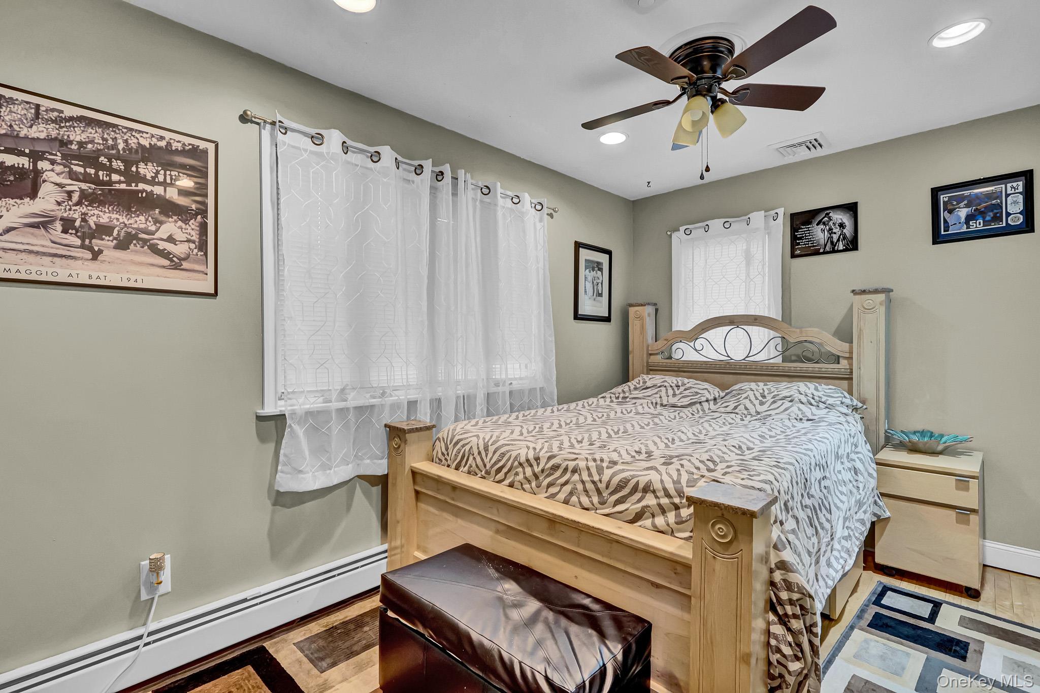 98 Granny Road Farmingville, NY 11738 - Photo 17 of 24 a bedroom with a bed and a chandelier