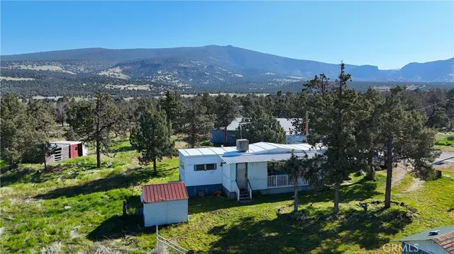 a view of a house with a yard in a patio