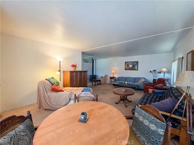 a bed room with a bed window and a chair