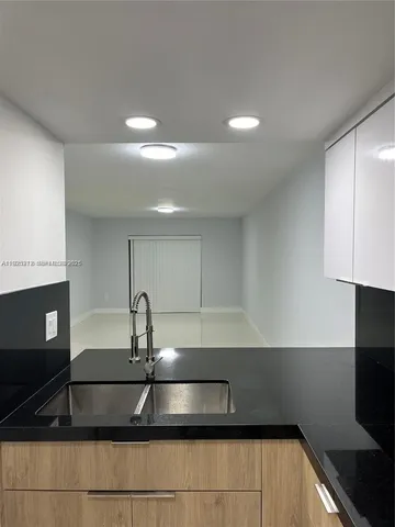 a kitchen with stainless steel appliances a sink stove and cabinets