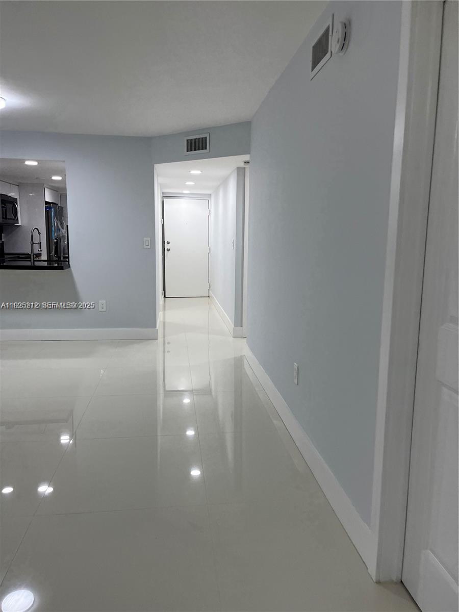 9917 West Okeechobee Road, Unit 203 Hialeah, FL 33016 - Photo 2 of 10 a view of a hallway