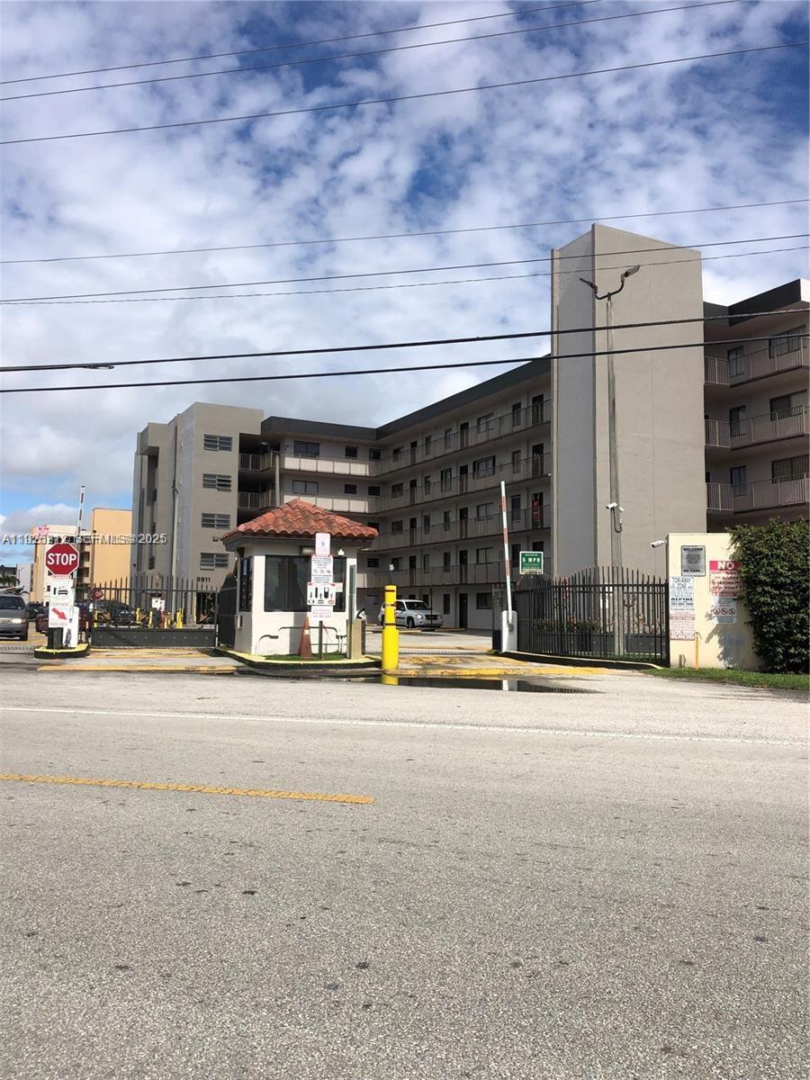 9917 West Okeechobee Road, Unit 203 Hialeah, FL 33016 - Photo 9 of 10 a view of a garage with car parked