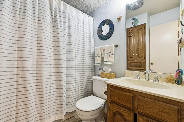 a bedroom with a bed a couch and dresser