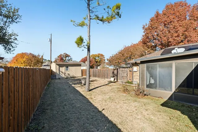a bedroom with a large bed and a large window with outer view