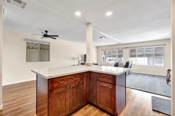 a kitchen with stainless steel appliances granite countertop a sink refrigerator and cabinets