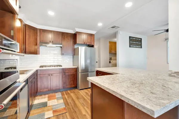 a kitchen with a refrigerator sink and stove