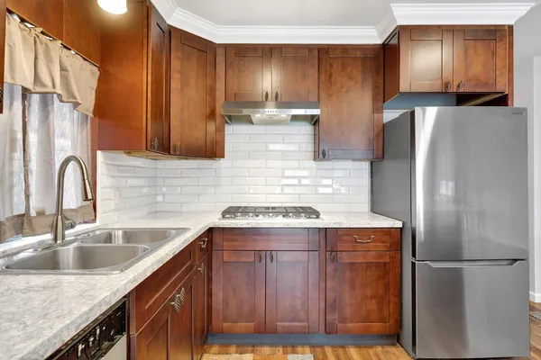 a kitchen with stainless steel appliances granite countertop a stove and a microwave