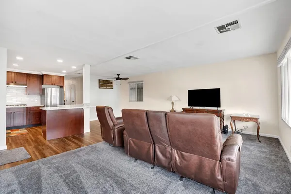 a living room with furniture and wooden floor