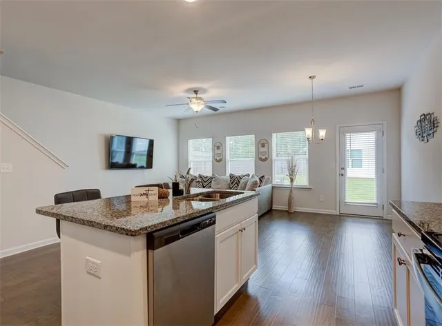a kitchen with sink stove and refrigerator