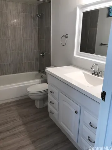 a bathroom with a toilet and bathtub