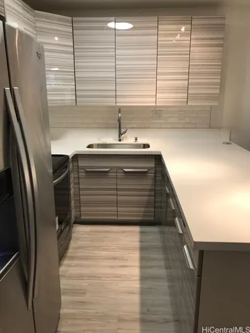 a kitchen with stainless steel appliances a refrigerator sink and microwave