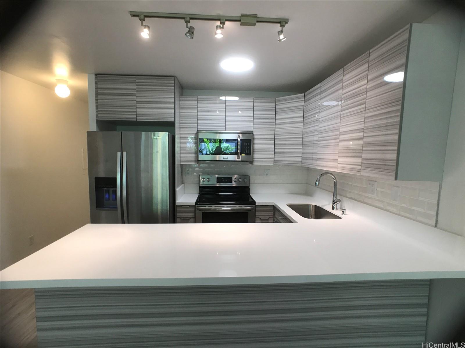 350 Aoloa Street, Unit A111 Kailua, HI 96734 - Photo 2 of 24 a bathroom with a sink and a large mirror