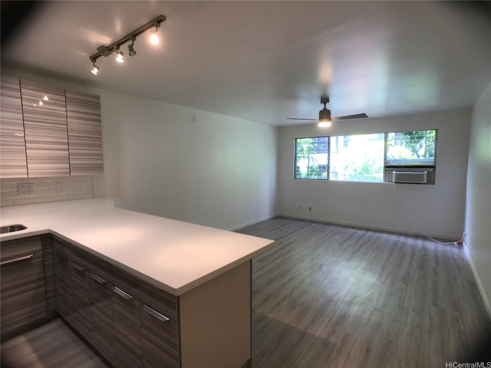350 Aoloa Street, Unit A111 Kailua, HI 96734 - Photo 21 of 24 an empty room with wooden floor and windows