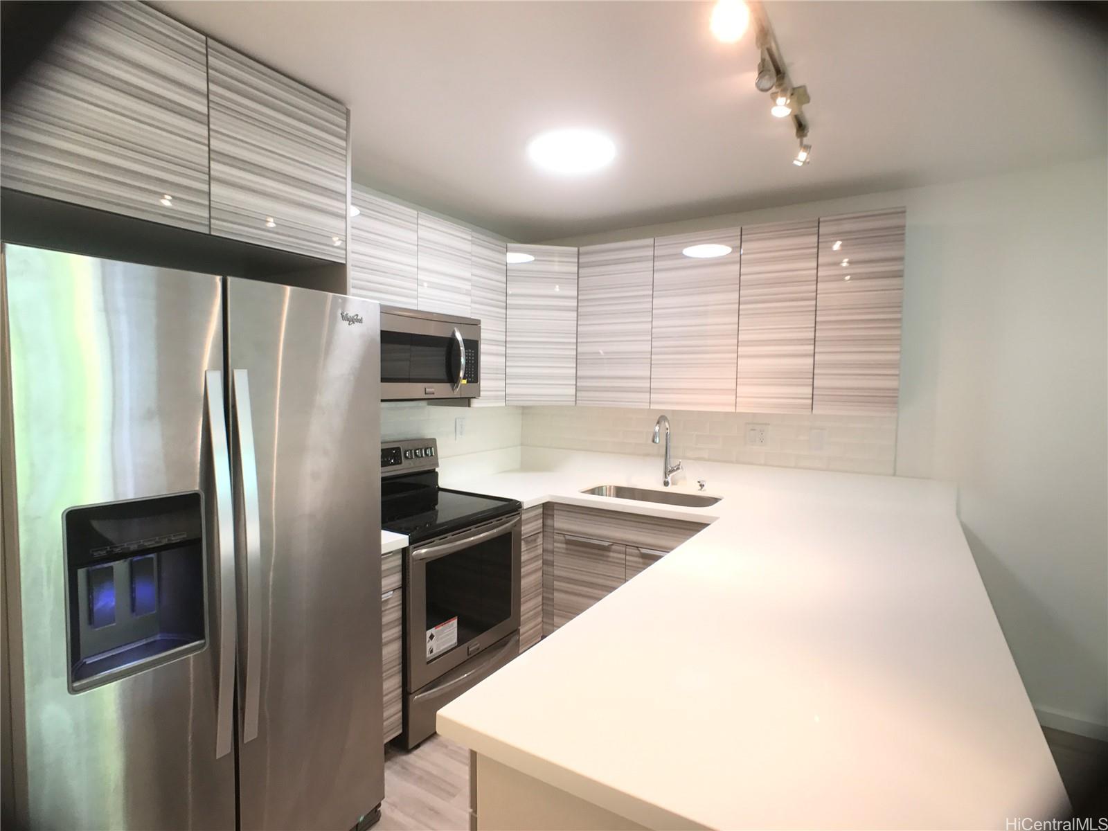 350 Aoloa Street, Unit A111 Kailua, HI 96734 - Photo 22 of 24 a kitchen with stainless steel appliances a refrigerator sink and microwave