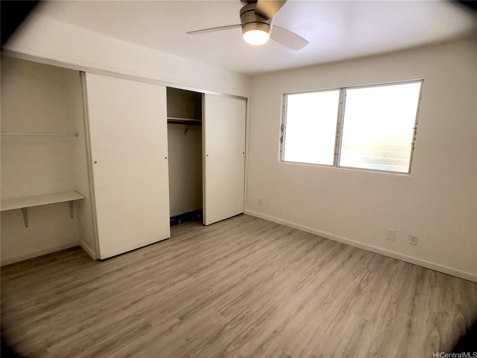 350 Aoloa Street, Unit A111 Kailua, HI 96734 - Photo 23 of 24 an empty room with wooden floor and windows