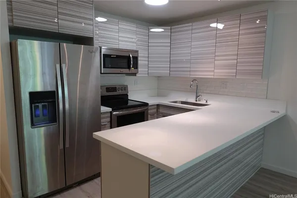 a kitchen with stainless steel appliances a refrigerator and a sink