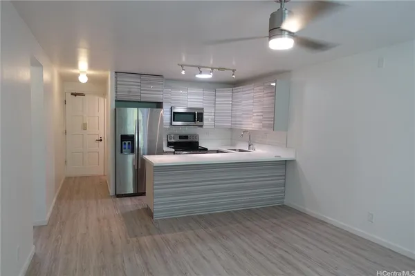 a view of room with closet and wooden floor