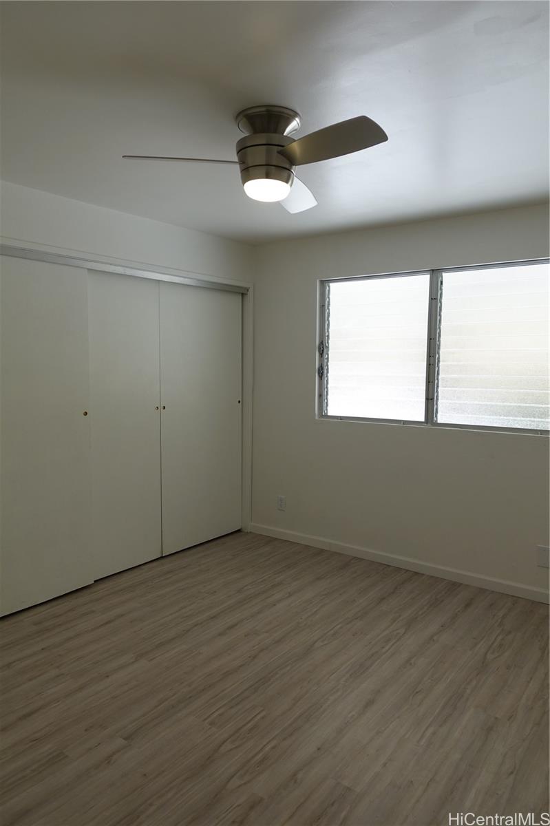 350 Aoloa Street, Unit A111 Kailua, HI 96734 - Photo 10 of 24 an empty room with wooden floor and windows
