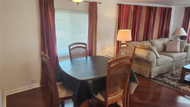 a dining room with furniture and wooden floor