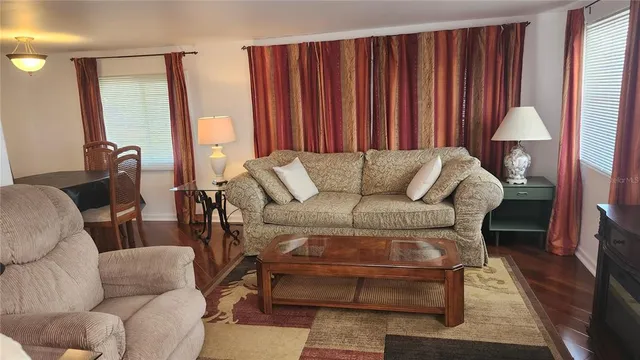 a living room with furniture a lamp and a potted plant