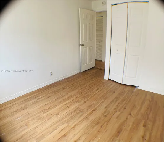 an empty room with wooden floor