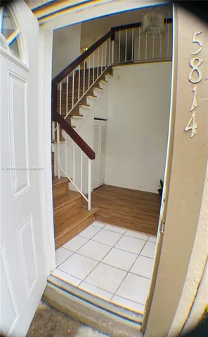 a view of staircase with white walls and railing