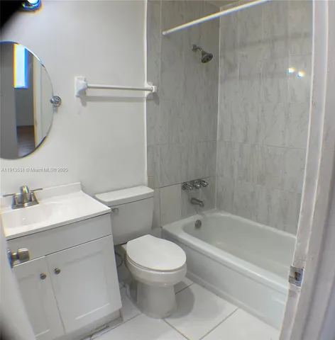 a bathroom with a sink toilet vanity and shower