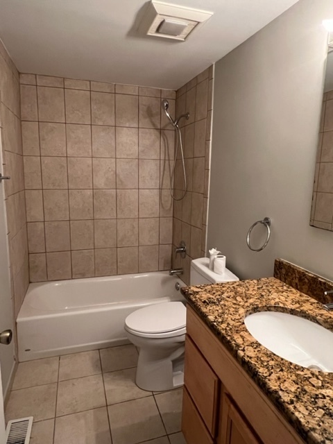 1010 Denham Place Schaumburg, IL 60169 - Photo 14 of 16 a bathroom with a granite countertop sink a toilet and bathtub