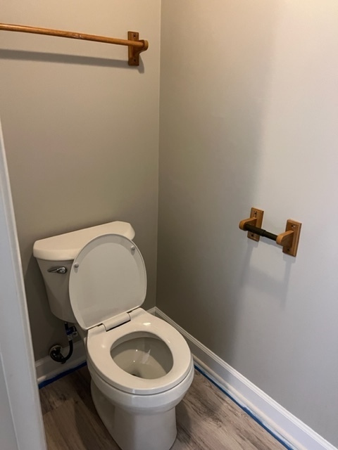 1010 Denham Place Schaumburg, IL 60169 - Photo 9 of 16 a white toilet sitting next to a wooden vanity