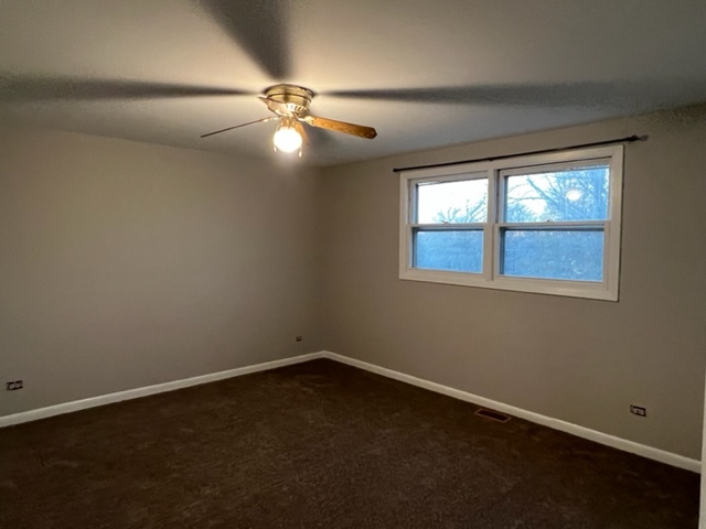 1010 Denham Place Schaumburg, IL 60169 - Photo 10 of 16 a view of an empty room with wooden floor and a window