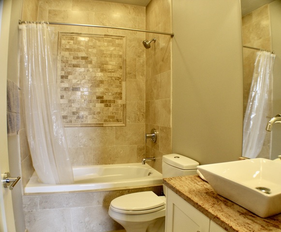 4029 South Ellis Avenue, Unit 5S Chicago, IL 60653 - Photo 18 of 31 a bathroom with a granite countertop sink toilet and shower