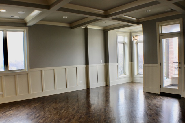 4029 South Ellis Avenue, Unit 5S Chicago, IL 60653 - Photo 9 of 31 a view of an empty room with wooden floor and a window