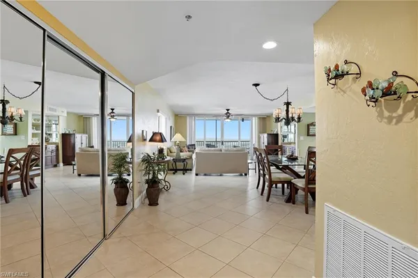 a living room with furniture kitchen and a table